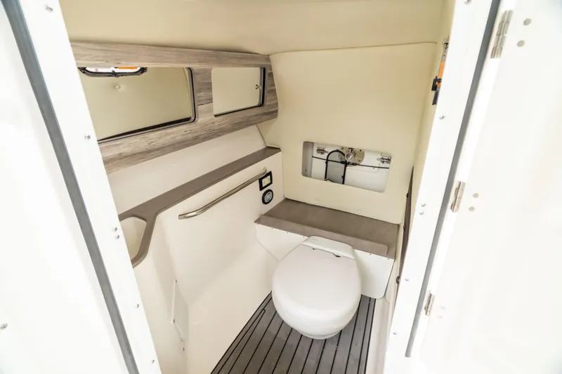 Slide: The Image of 2023 Edgewater 248 CX boat interior with modern bathroom amenities and sleek design. - 48
