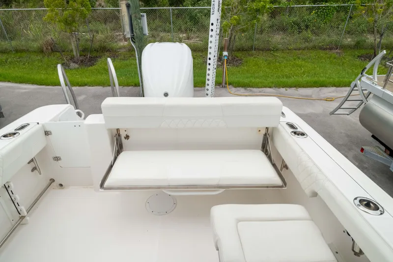 Slide: The Image of 2023 Edgewater 248 CX boat with white seating and stainless steel accents. - 5