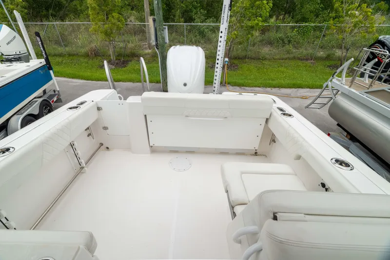 Slide: The Image of 2023 Edgewater 248 CX boat interior with white seating and spacious deck area. - 6