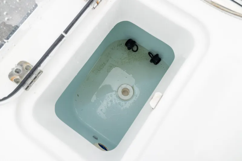 Slide: The Image of Livewell compartment on 2023 Edgewater 248 CX boat, featuring clean interior design. - 9