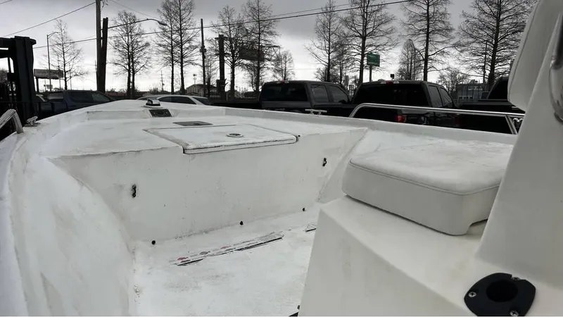 Slide: The Image of 2000 Blazer 186 boat on trailer, parked outdoors near RVs and other boats. - 2