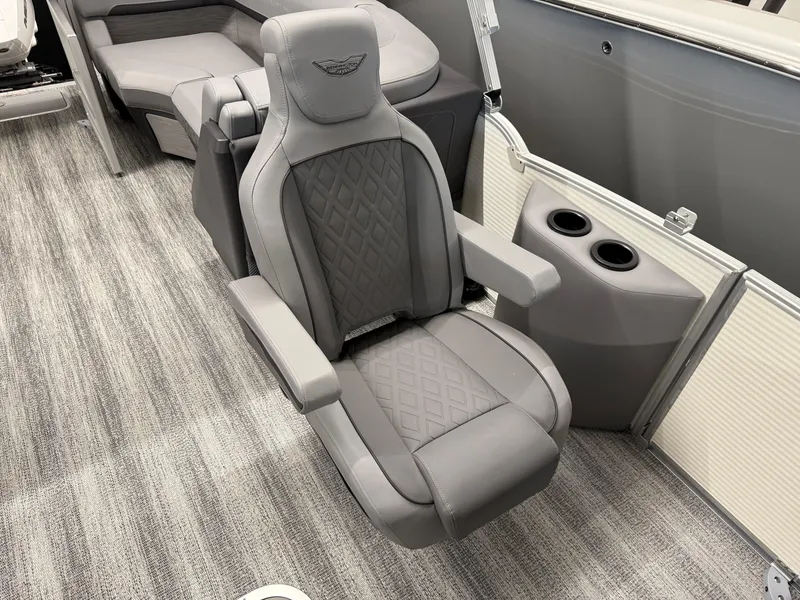 Slide: The Image of 2025 Bennington M Line boat interior with luxurious gray seating and cup holders. - 10