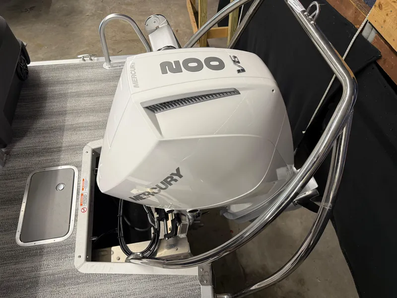 Slide: The Image of 2025 Bennington M Line boat with Mercury 200 V6 outboard engine, docked indoors. - 12