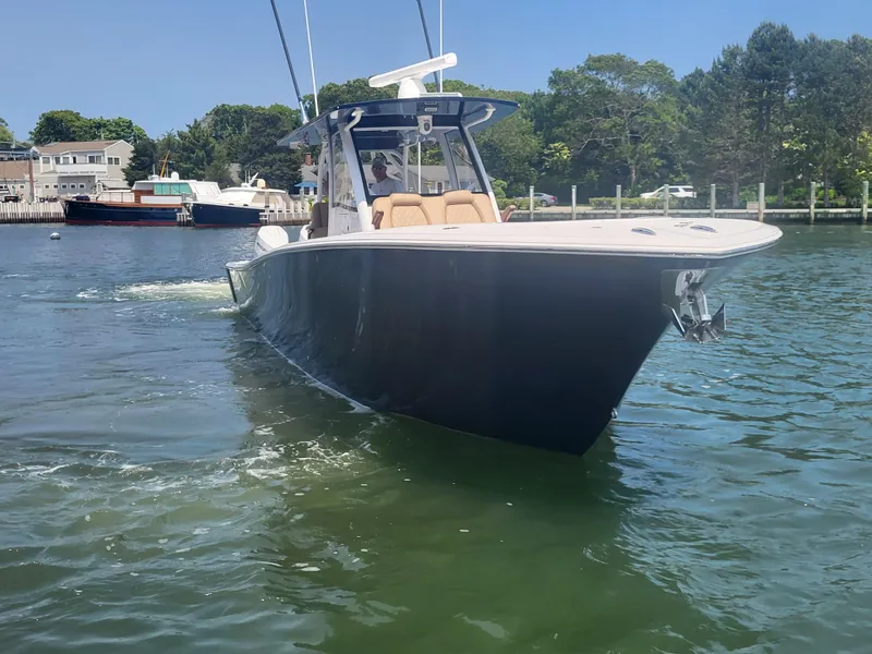 Slide: The Image of 2025 Front Runner 39 boat cruising on a sunny day in a marina. - 12