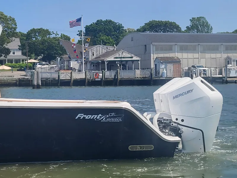 Slide: The Image of 2025 Front Runner 39 boat with Mercury engine docked near waterfront buildings. - 13