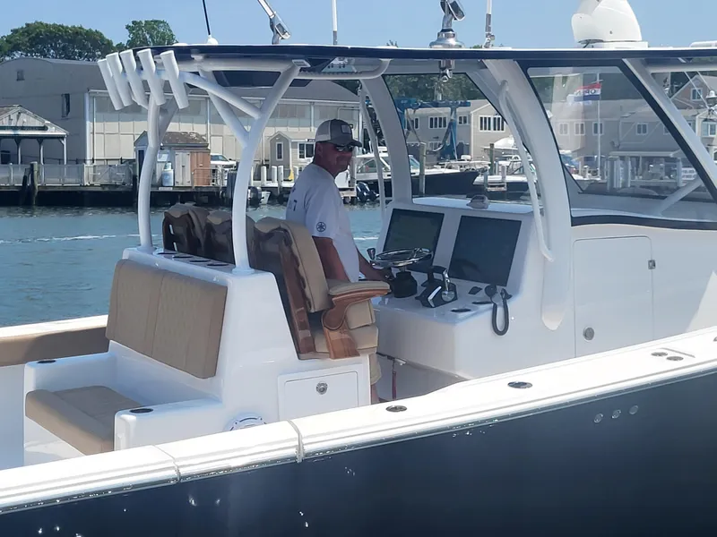 Slide: The Image of 2025 Front Runner 39 boat with captain at helm, docked in marina. - 16