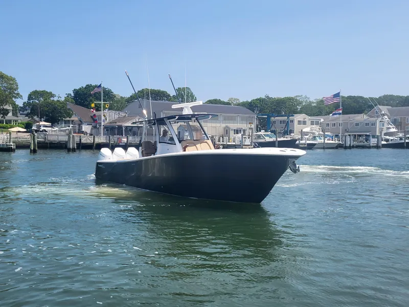 Slide: The Image of 2025 Front Runner 39 boat cruising in a marina with waterfront homes in the background. - 19