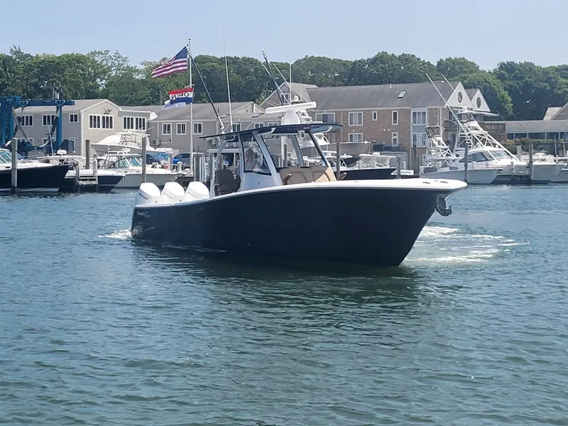 Slide: The Image of 2025 Front Runner 39 boat cruising in a marina with buildings in the background. - 22