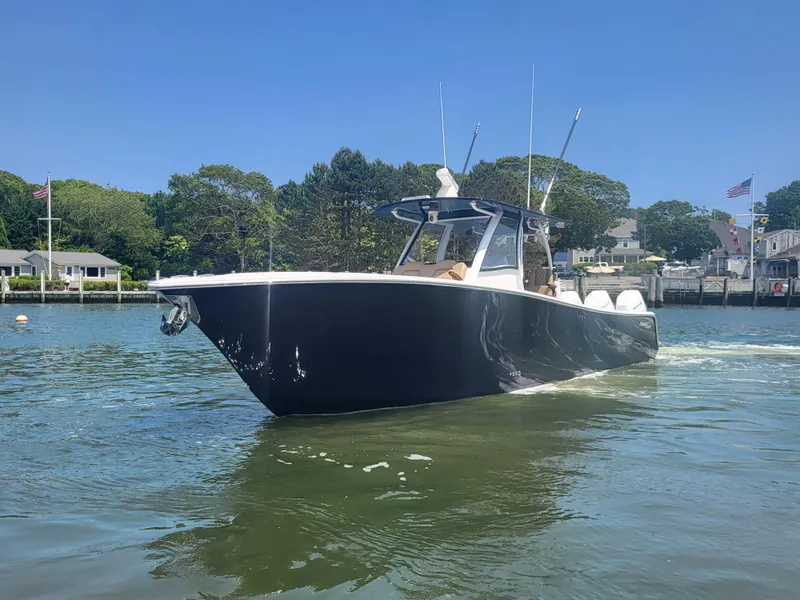 Slide: The Image of 2025 Front Runner 39 boat cruising on a sunny day in a scenic harbor. - 4