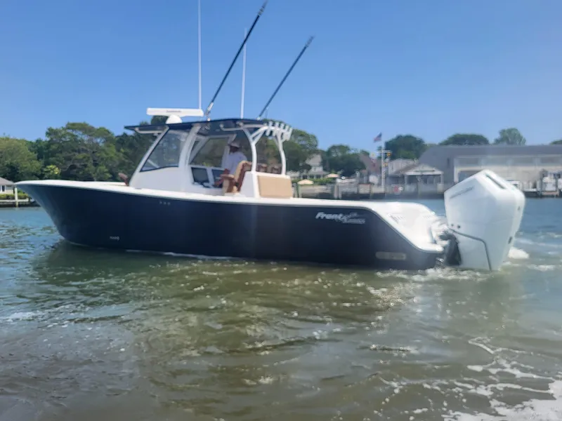 Slide: The Image of 2025 Front Runner 39 boat cruising on a sunny day in a calm waterway. - 5