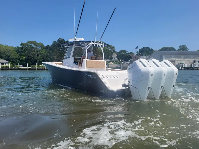 Slide: The Image of 2025 Front Runner 39 boat with triple engines on calm water. - 6