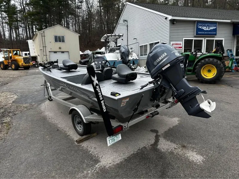 Slide: The Image of 2018 Xpress XP7 boat with Yamaha motor on trailer, parked outside a dealership. - 2