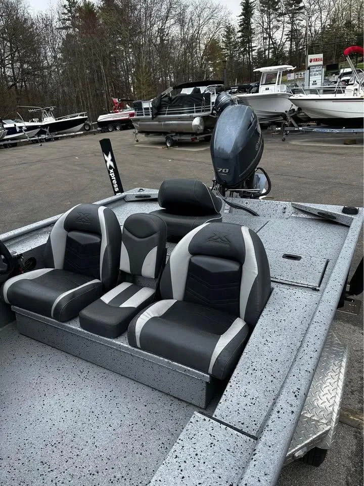Slide: The Image of 2018 Xpress XP7 boat with sleek seating, parked among other boats. - 3