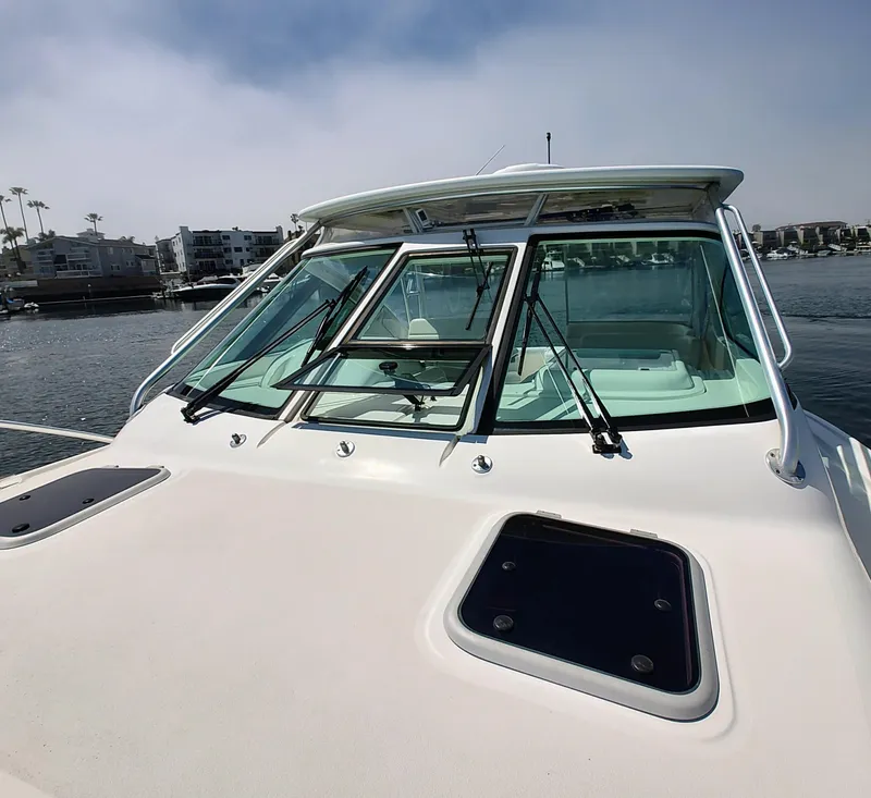 Slide: The Image of 2008 Tiara Yachts 3200 Open boat on water, showcasing windshield and deck. - 13