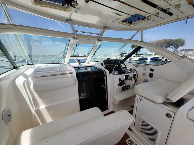 Slide: The Image of 2008 Tiara Yachts 3200 Open cockpit with white seating and modern controls. - 18