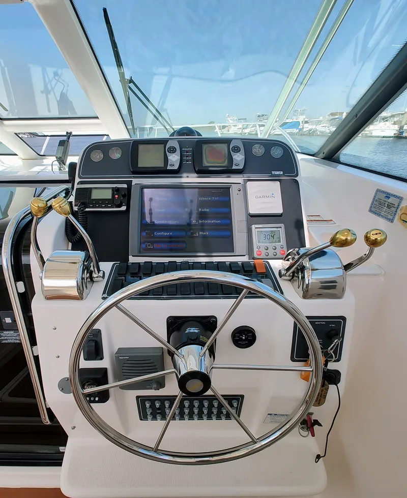 Slide: The Image of Helm of 2008 Tiara Yachts 3200 Open with navigation controls and steering wheel. - 19