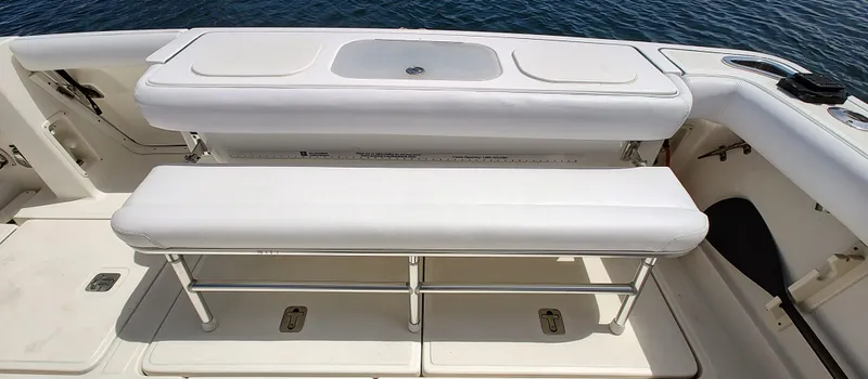 Slide: The Image of 2008 Tiara Yachts 3200 Open boat seating area with white cushioned benches. - 22