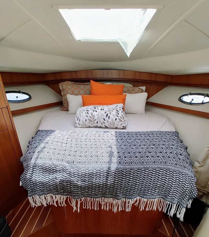 Slide: The Image of Cozy cabin interior of 2008 Tiara Yachts 3200 Open with skylight and decorative pillows. - 28