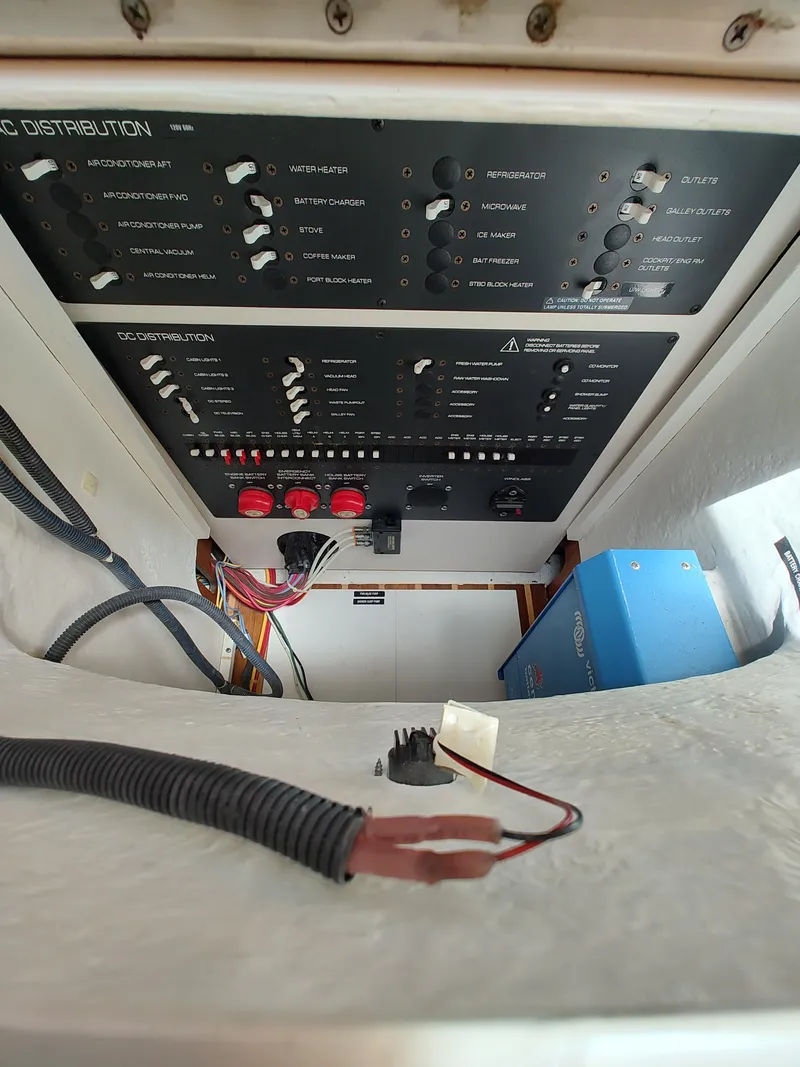 Slide: The Image of Electrical panel of 2008 Tiara Yachts 3200 Open, showcasing control switches and wiring. - 33