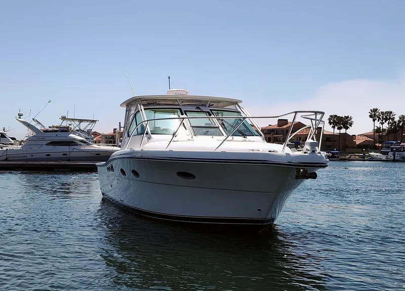 Slide: The Image of 2008 Tiara Yachts 3200 Open boat on water, sunny day, marina background. - 4