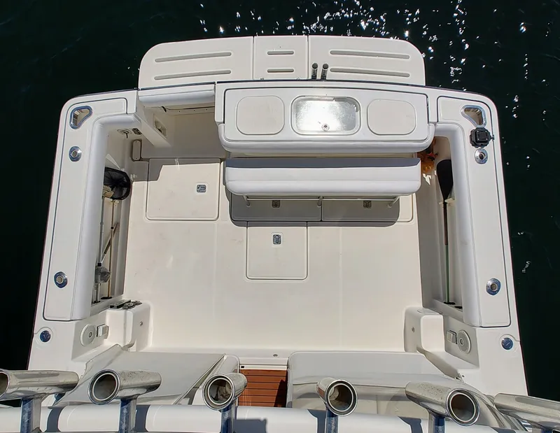 Slide: The Image of 2008 Tiara Yachts 3200 Open boat deck, featuring spacious seating and storage compartments. - 8