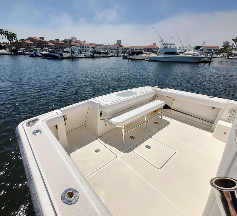 Slide: The Image of 2008 Tiara Yachts 3200 Open boat docked in a marina, featuring spacious deck area. - 9