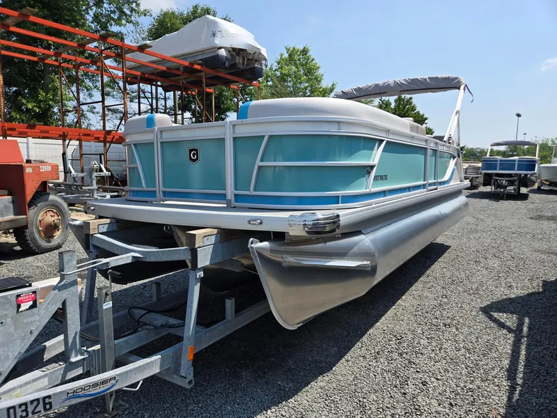 The Image of 2026 Godfrey SWEETWATER 2286 SB pontoon boat on trailer, parked outdoors. - 0