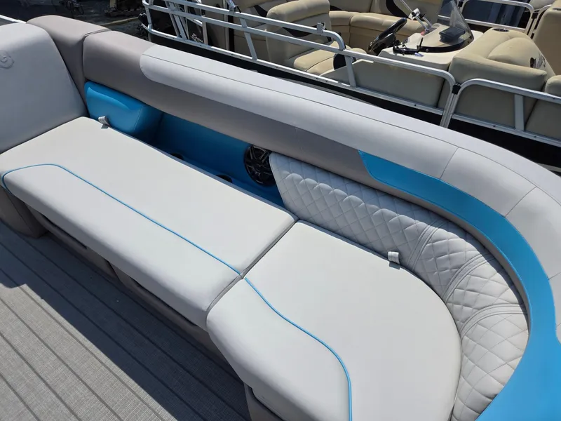 Slide: The Image of Luxurious seating on 2026 Godfrey SWEETWATER 2286 SB pontoon boat, featuring elegant blue accents. - 12