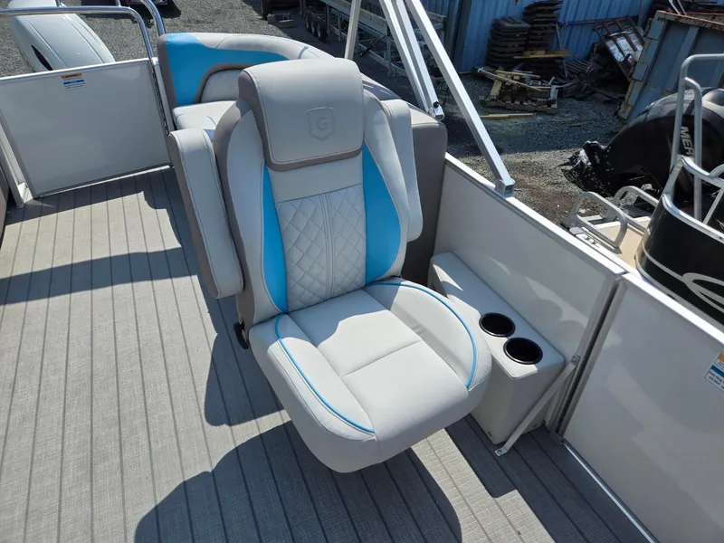 Slide: The Image of 2026 Godfrey SWEETWATER 2286 SB boat seat with cup holders, featuring blue and gray upholstery. - 14