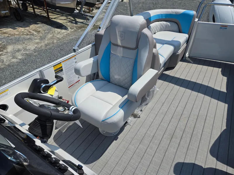 Slide: The Image of 2026 Godfrey SWEETWATER 2286 SB boat interior with plush seating and steering wheel. - 15