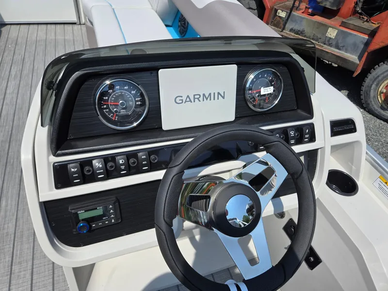 Slide: The Image of Steering console of 2026 Godfrey SWEETWATER 2286 SB with Garmin display and controls. - 16