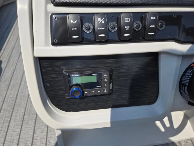 Slide: The Image of Control panel of 2026 Godfrey SWEETWATER 2286 SB boat with switches and audio system. - 18