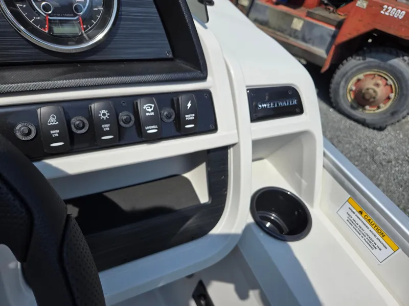 Slide: The Image of 2026 Godfrey SWEETWATER 2286 SB dashboard with controls and cup holder. - 19