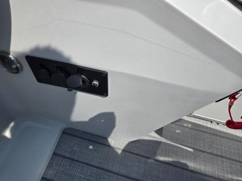 Slide: The Image of 2026 Godfrey SWEETWATER 2286 SB boat interior detail with control panel and flooring. - 20