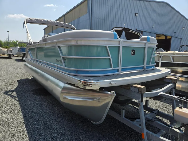 Slide: The Image of 2026 Godfrey SWEETWATER 2286 SB pontoon boat on trailer, parked outdoors. - 8