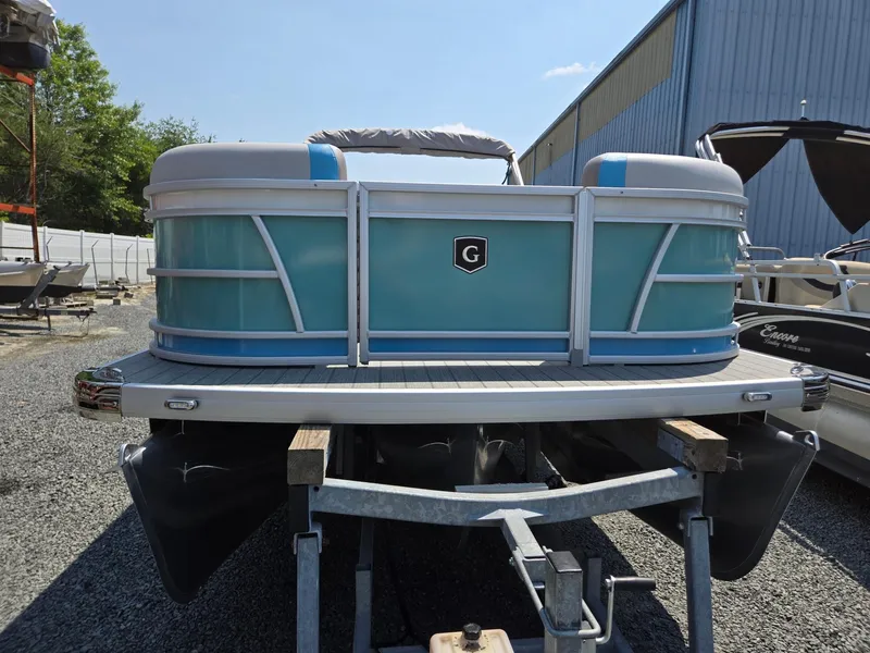 Slide: The Image of 2026 Godfrey SWEETWATER 2286 SB pontoon boat on trailer, blue and white design. - 9