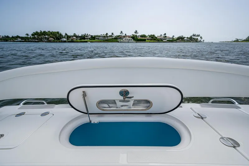 Slide: The Image of 2015 Bahama 41 boat with open hatch, ocean view, and distant shoreline. - 11