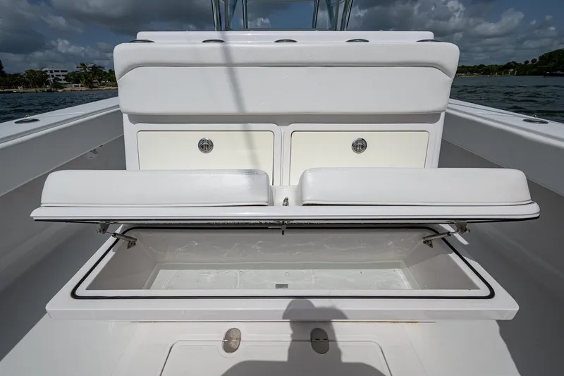 Slide: The Image of 2015 Bahama 41 boat storage compartment with open lid, showcasing spacious interior. - 14