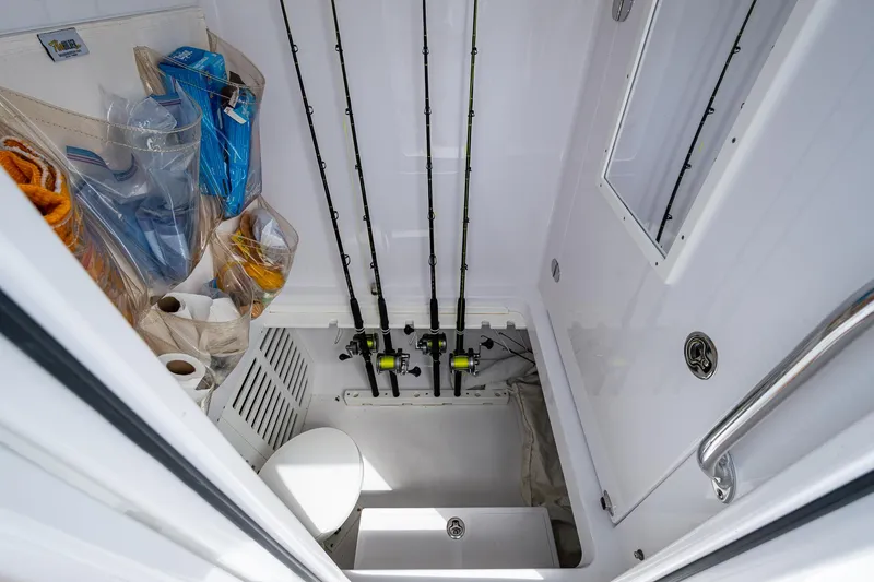 Slide: The Image of 2015 Bahama 41 boat storage area with fishing rods and gear. - 18
