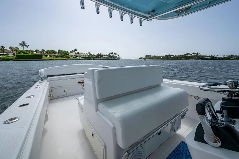 Slide: The Image of 2015 Bahama 41 boat interior with white seating, overlooking a serene waterfront view. - 22
