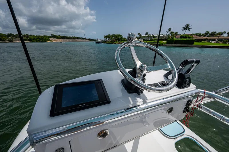 Slide: The Image of Helm of 2015 Bahama 41 boat with steering wheel and navigation screen. - 23