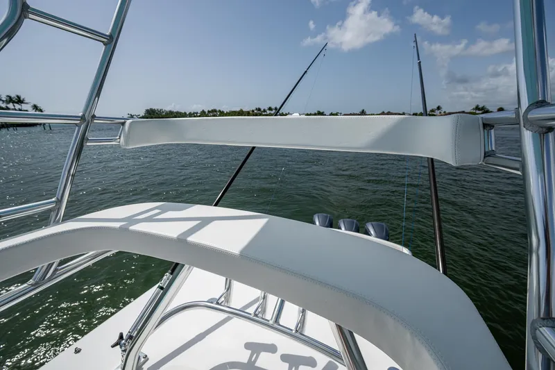 Slide: The Image of 2015 Bahama 41 boat with fishing rods, ocean view, and clear sky. - 24
