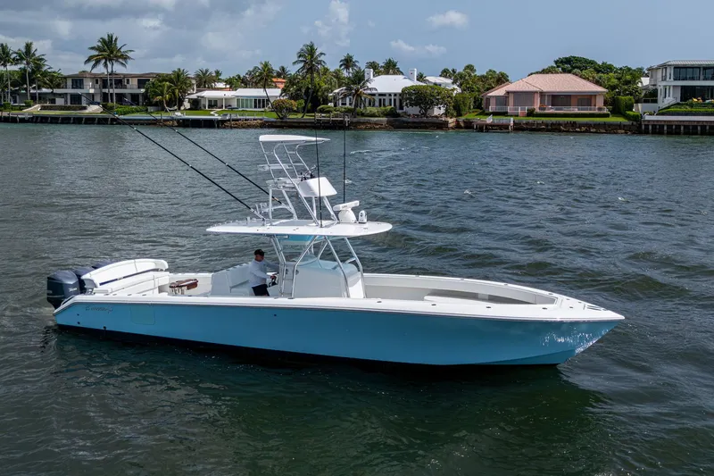 Slide: The Image of 2015 Bahama 41 boat on water, with coastal homes in the background. - 25