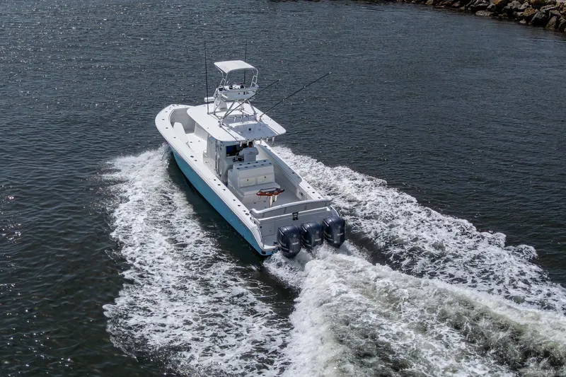 Slide: The Image of 2015 Bahama 41 boat cruising on open water with dual engines. - 27