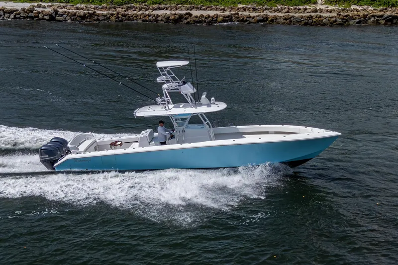 Slide: The Image of 2015 Bahama 41 boat cruising on water, featuring sleek design and powerful engines. - 28