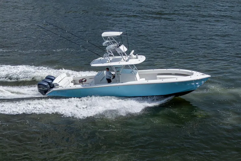Slide: The Image of 2015 Bahama 41 boat cruising on water with dual outboard engines. - 29