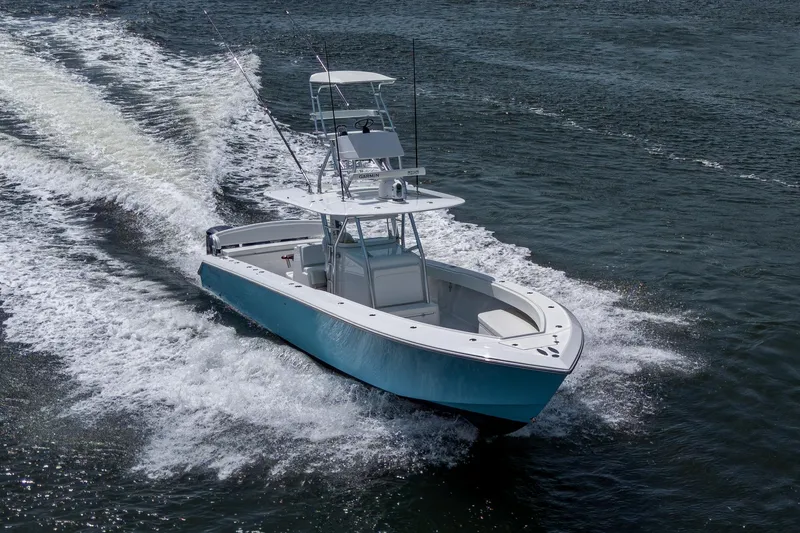 Slide: The Image of 2015 Bahama 41 boat cruising on open water, creating a wake. - 32