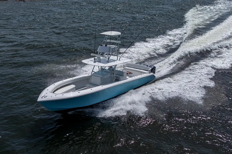 Slide: The Image of 2015 Bahama 41 boat cruising on open water, creating a dynamic wake. - 34