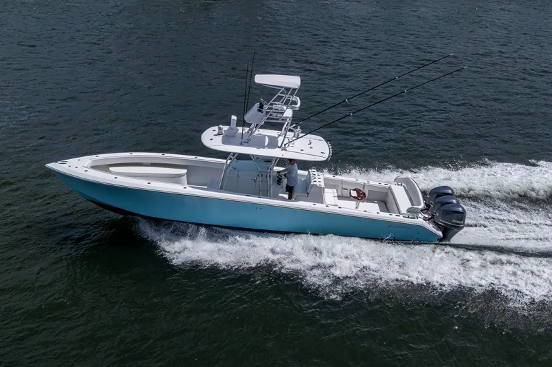 Slide: The Image of 2015 Bahama 41 boat cruising on water with triple outboard engines. - 35