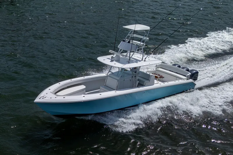 Slide: The Image of 2015 Bahama 41 boat cruising on water, featuring sleek design and powerful engines. - 36